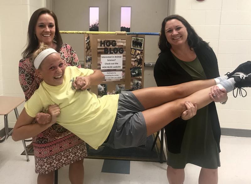 Cape High Principal Nikki Miller, left, and Cape High FFA Advisor Ryan Ellis support Riley in her work.